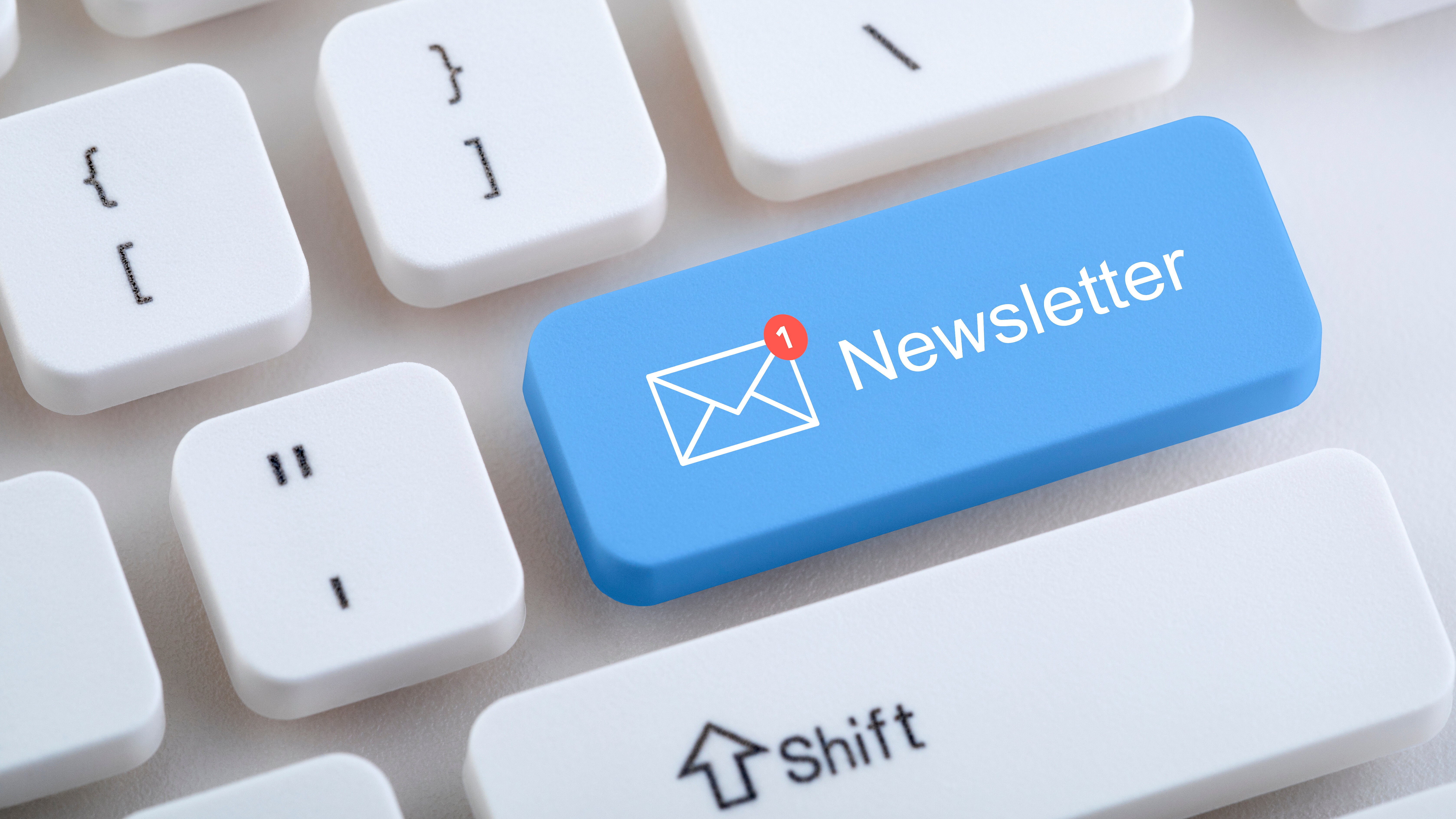 Computer keyboard with a highlighted “Newsletter” key and email icon.