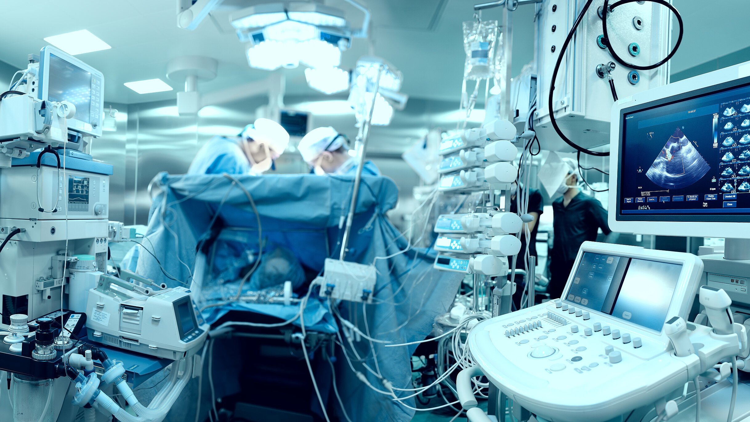 Operating room with medical equipment, monitoring systems, and a surgical team during a procedure.
