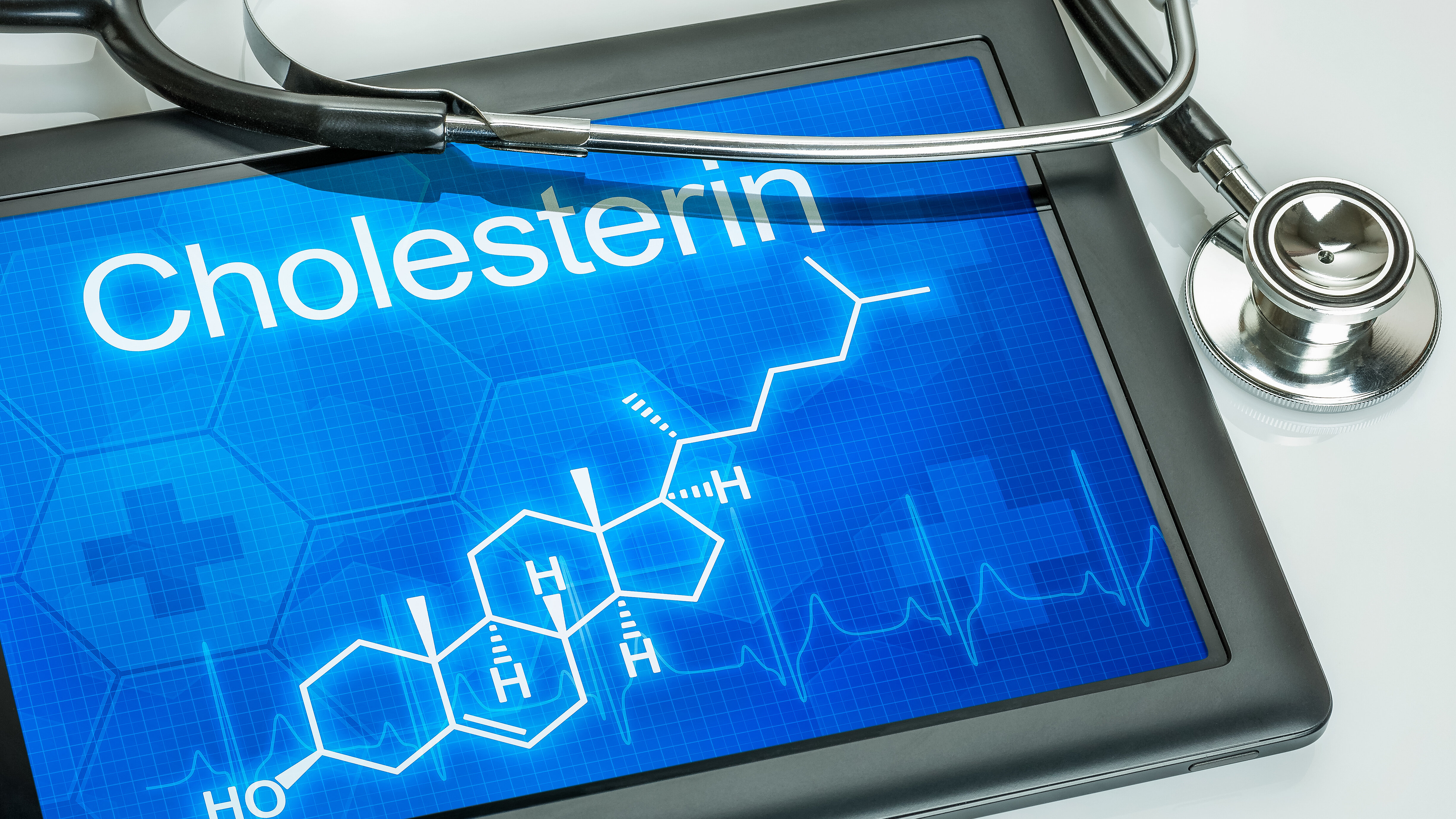 Tablet displaying the chemical structure of cholesterol with a stethoscope, symbolizing cardiovascular health and cholesterol management.